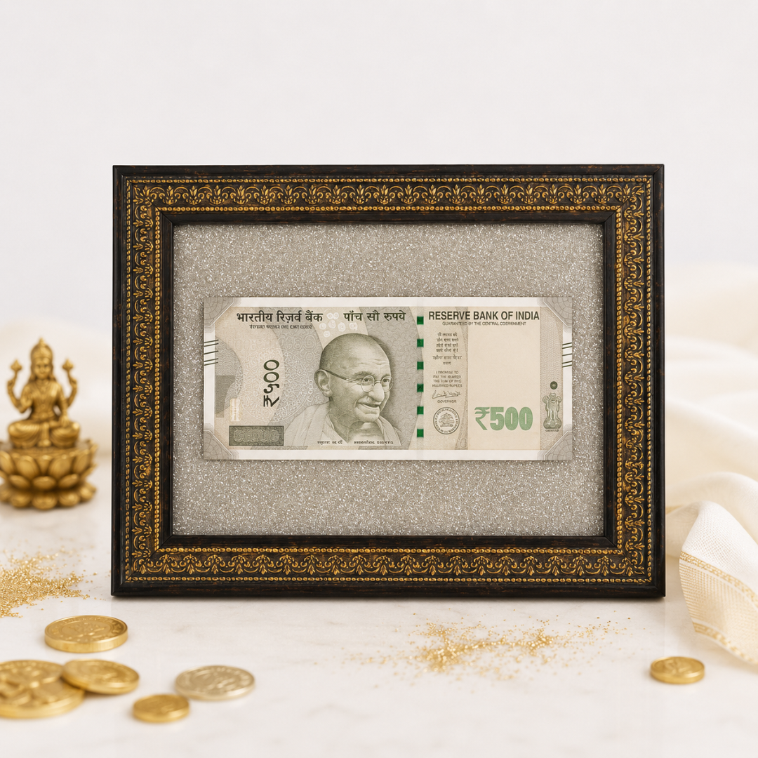 Energized Pyrite Frame with real 500 rupee note, placed beside a Lakshmi idol and gold coins